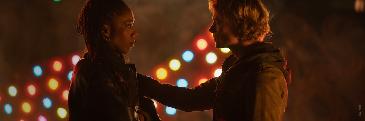 Naomi Ackie and Tom Rhys Harries face each other outdoors in Clayface.