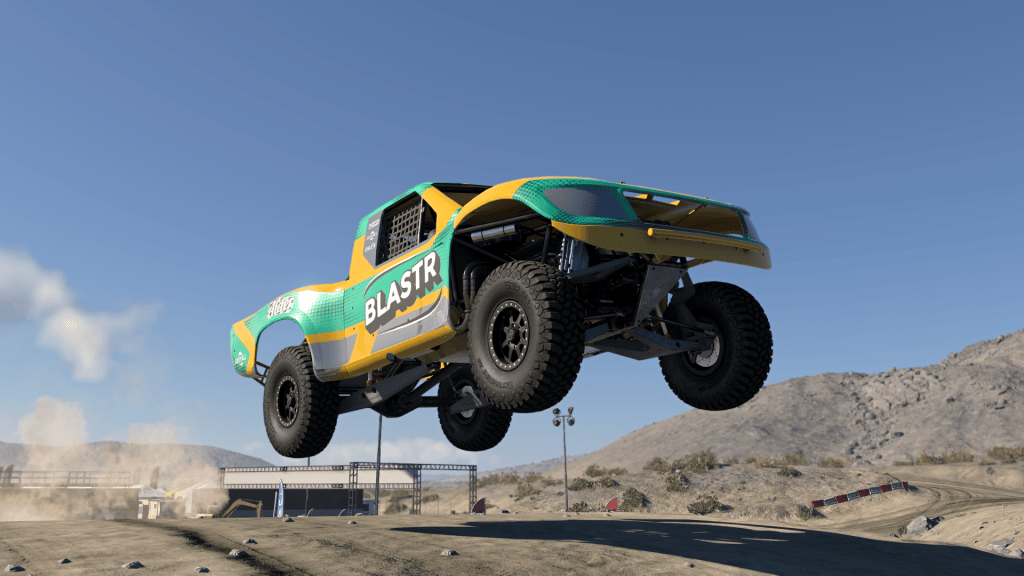 Green-and-yellow SP Dunekicker racing truck airborne above an off-road course in BeamNG.drive on PS5.