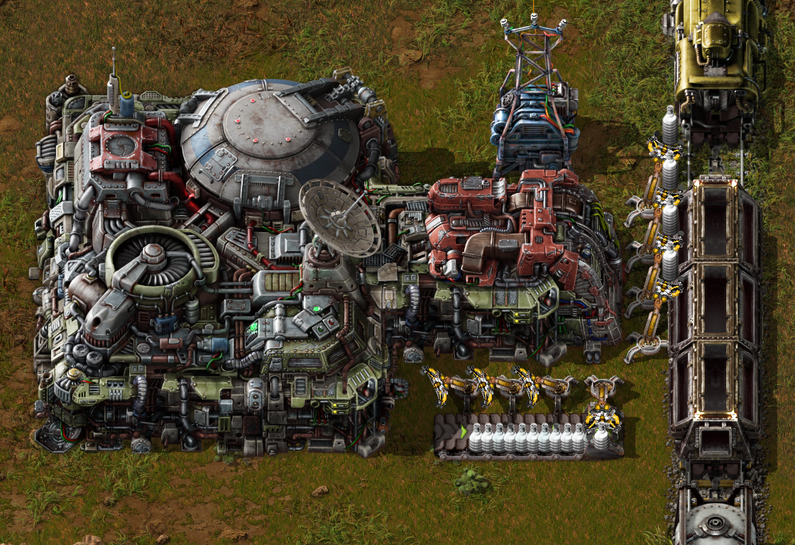 Factorio landing pad and unloading bays feeding items into a train using inserters