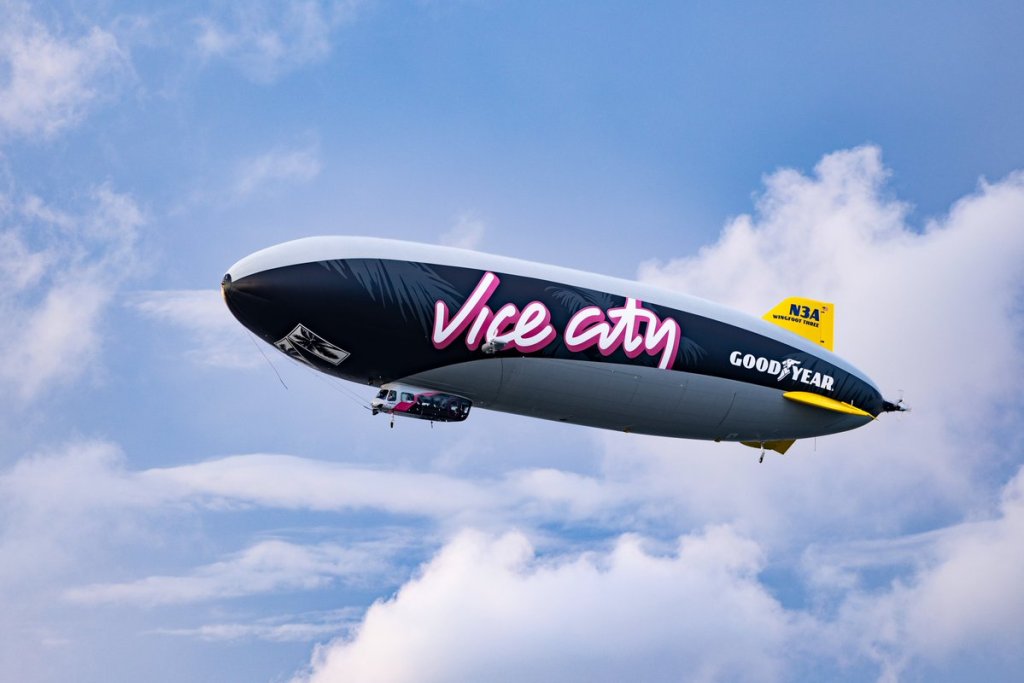 Goodyear's Wingfoot Three blimp with pink Vice City lettering against a blue sky.