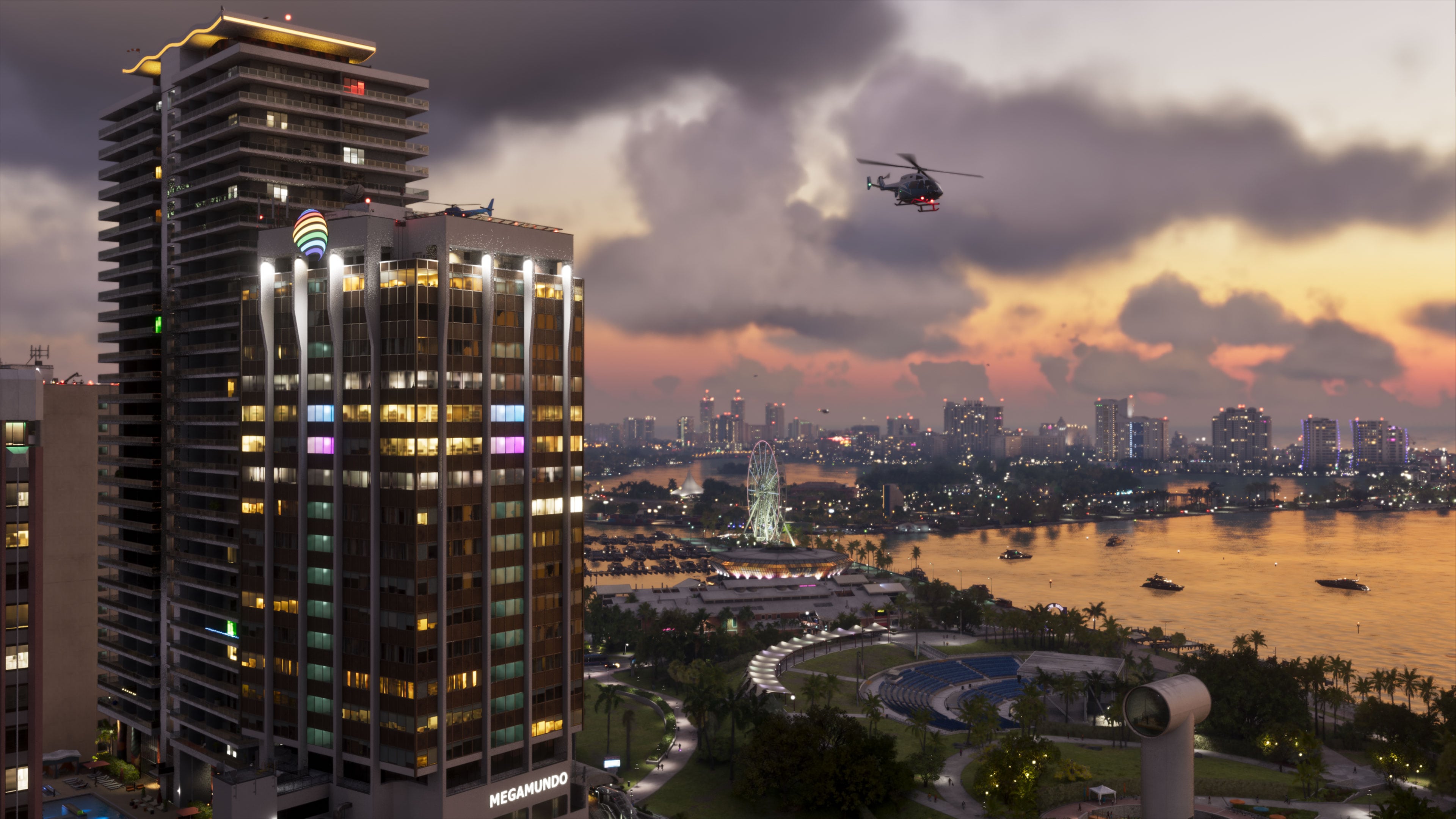 A helicopter flies above Vice City’s illuminated waterfront at sunset in an official GTA VI screenshot.