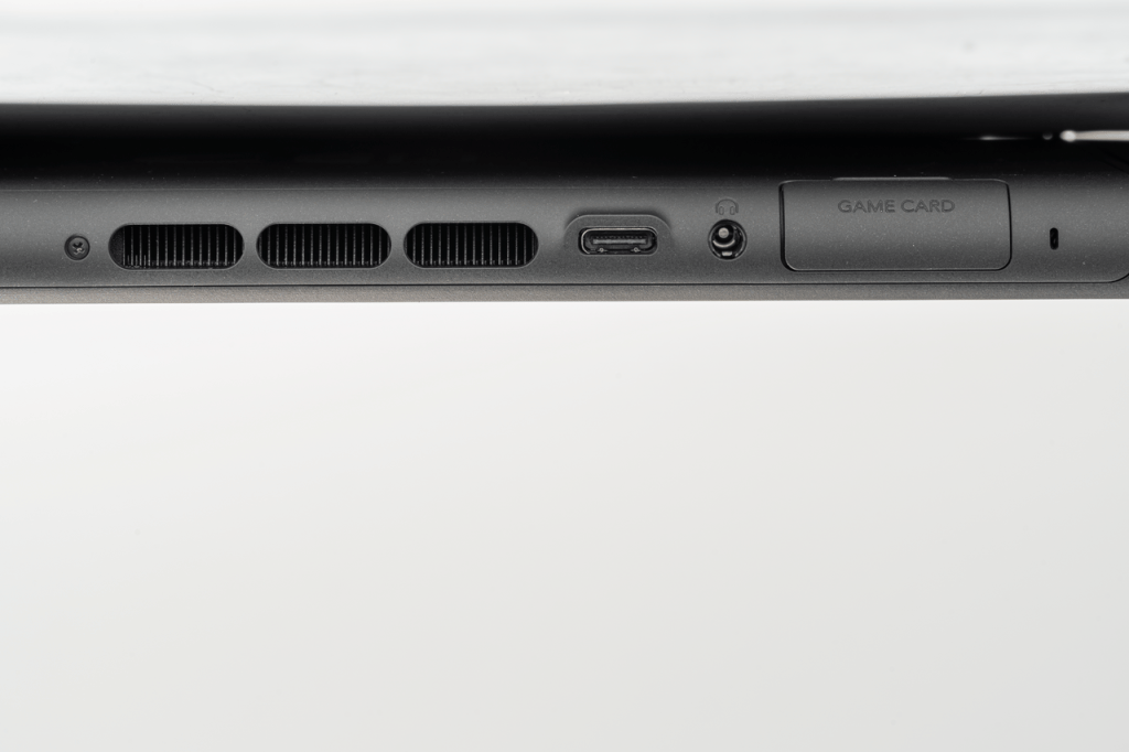 Top edge of a Nintendo Switch 2, showing its game-card slot, headphone socket, USB-C port and vents.