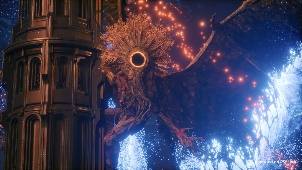 A towering Saros creature with an eclipse-like circular face beside an alien pillar, surrounded by blue and orange light.